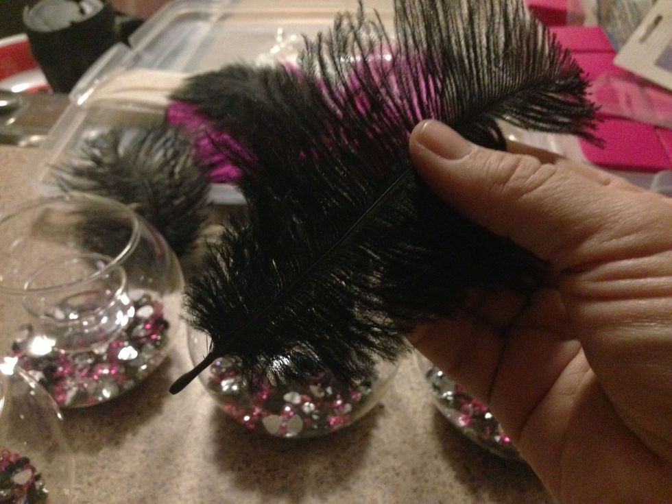 Add a small dab of hot glue to the bottom of the feather.