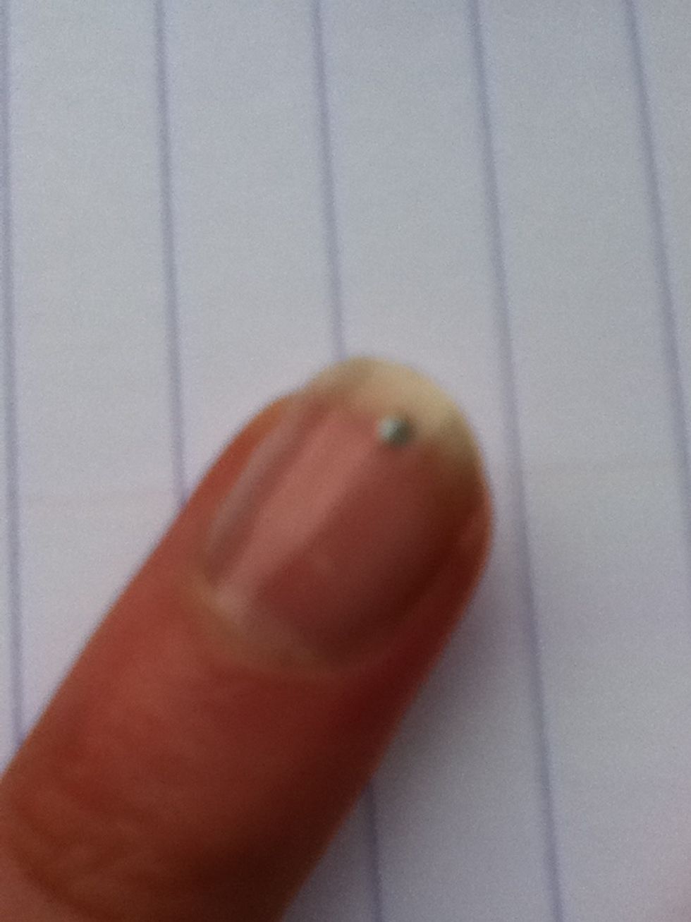 Add a small dot of silver nail polish near the top of the nail and slightly to the right (you can use a small jewel if you want instead).