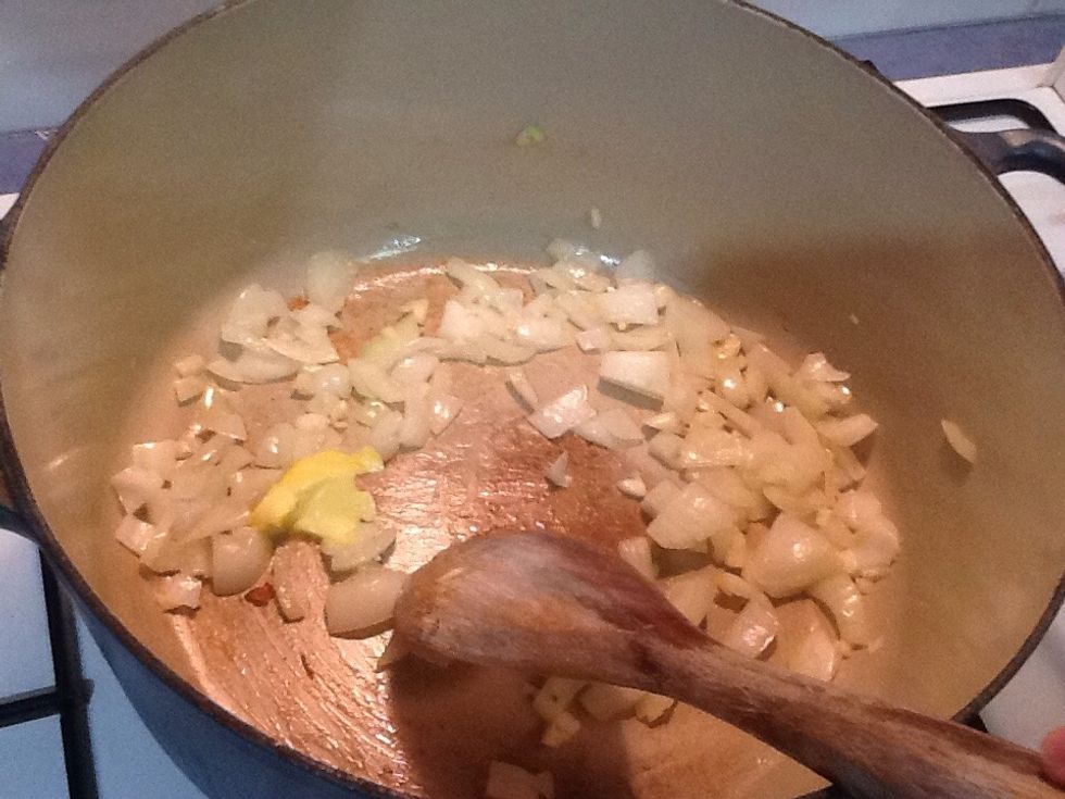 Add a small knob of butter to a heavy based sauce pan and saut\u00e9 onion and garlic for two minutes on a medium heat.