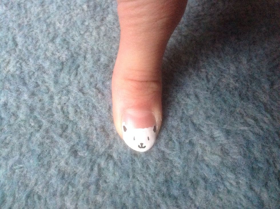 Add a small oval for its nose and draw a line going down underneath it and then split and flick the end of the line.