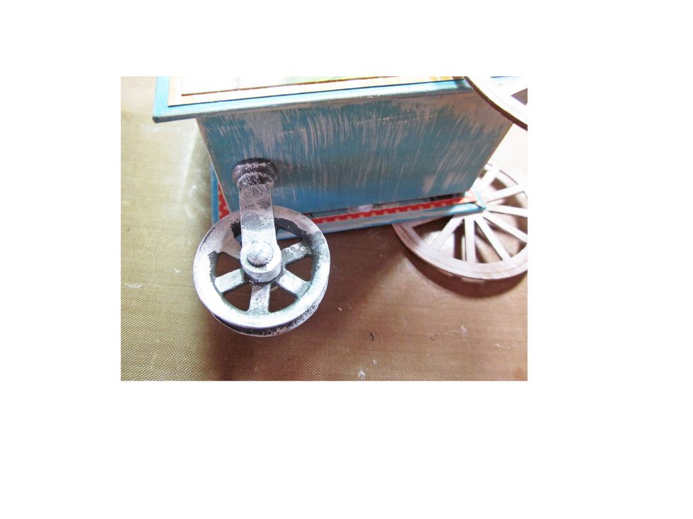 Add a small pulley wheel to the bottom of the middle/front of the cart.  Again if you don't have a pulley wheel you could just add a solid peg for balance.