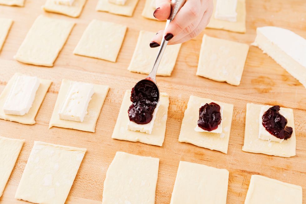Add a small spoonful of cherry jam on top of each brie bite.
