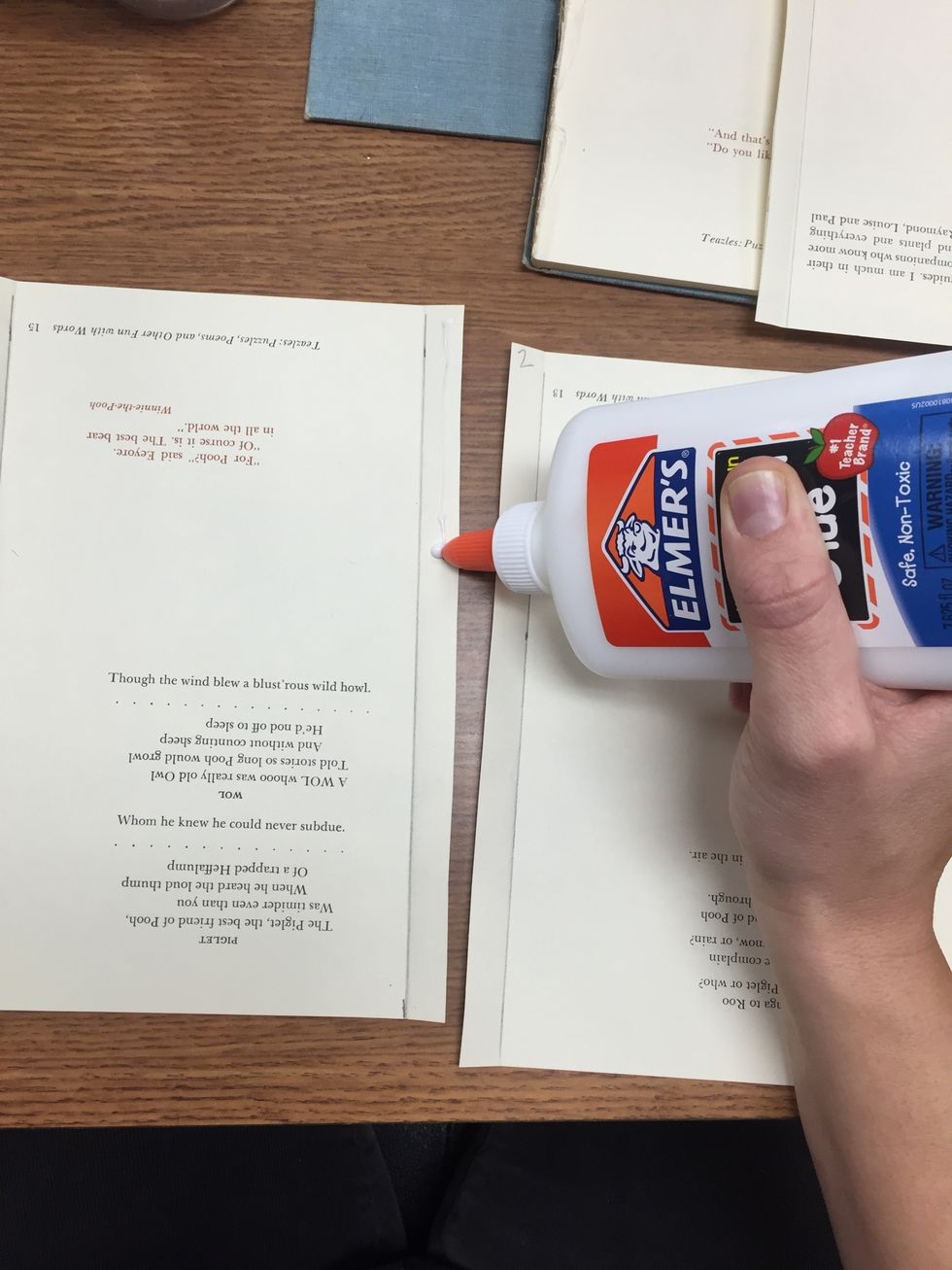 Add a small THIN line of glue to the right folded side of the first page.