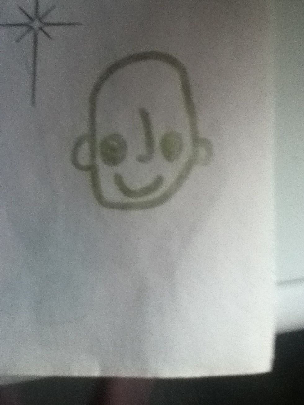 Add a smile and a dot in the eyes with a circle around it