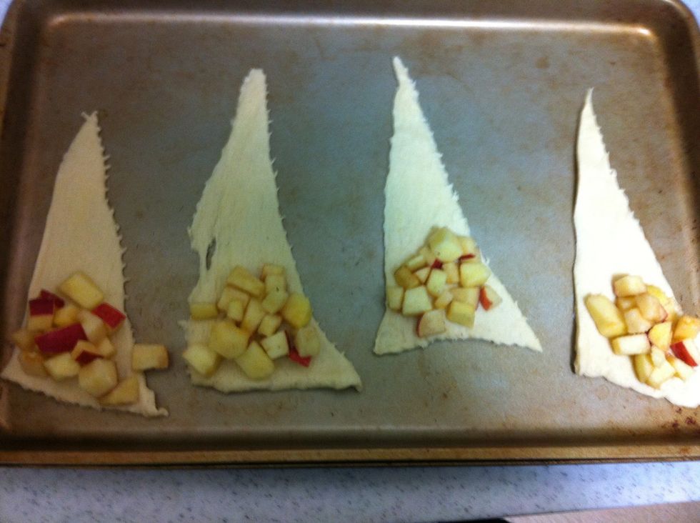 Add a spoonful of the apple sugar mix to each crescent roll