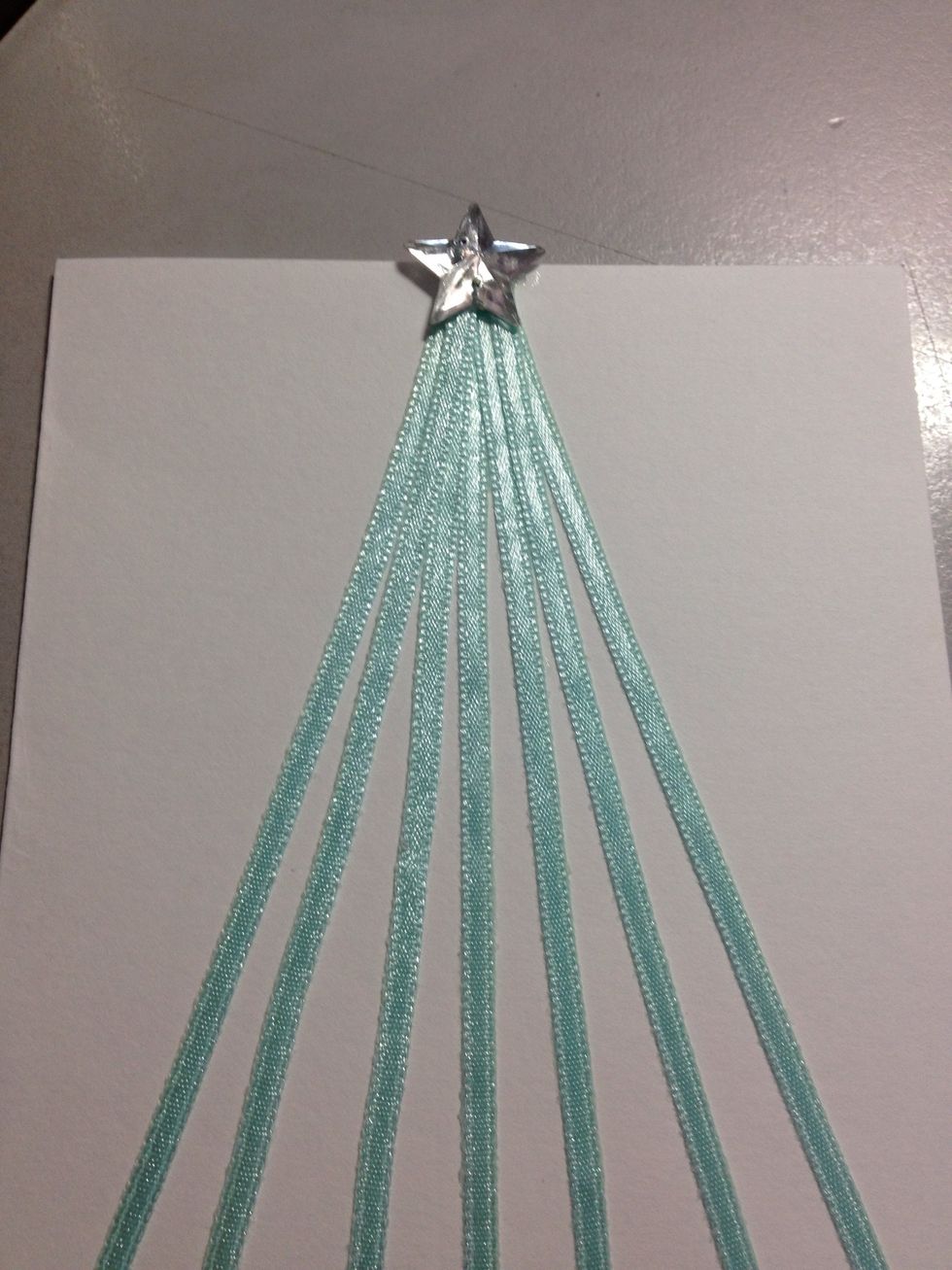 Add a star or any other shape which is large enough for the tree. Best if you are able to use super glue for this.