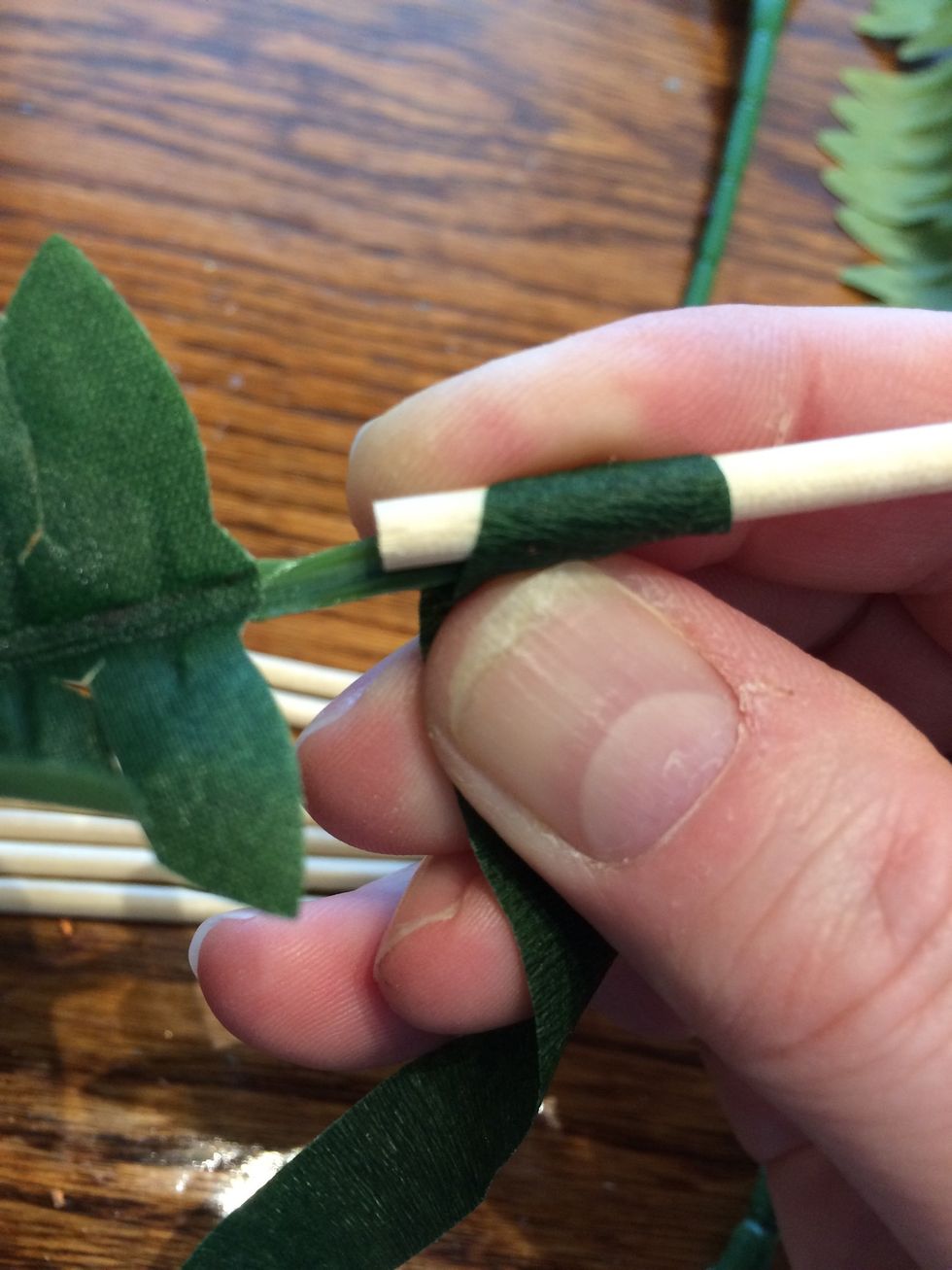 Add a stem using the dowel and florist tape. The tape works best when stretched lightly as you wrap. Remember to spin/twist your work, not the tape. Go over the joint until it is secure.