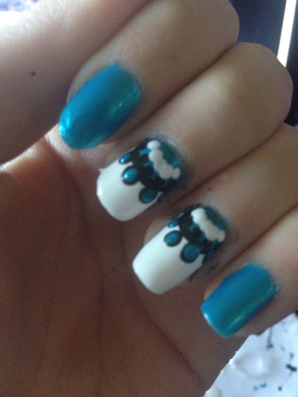 Add a string of white dots that also touch the small black dots.