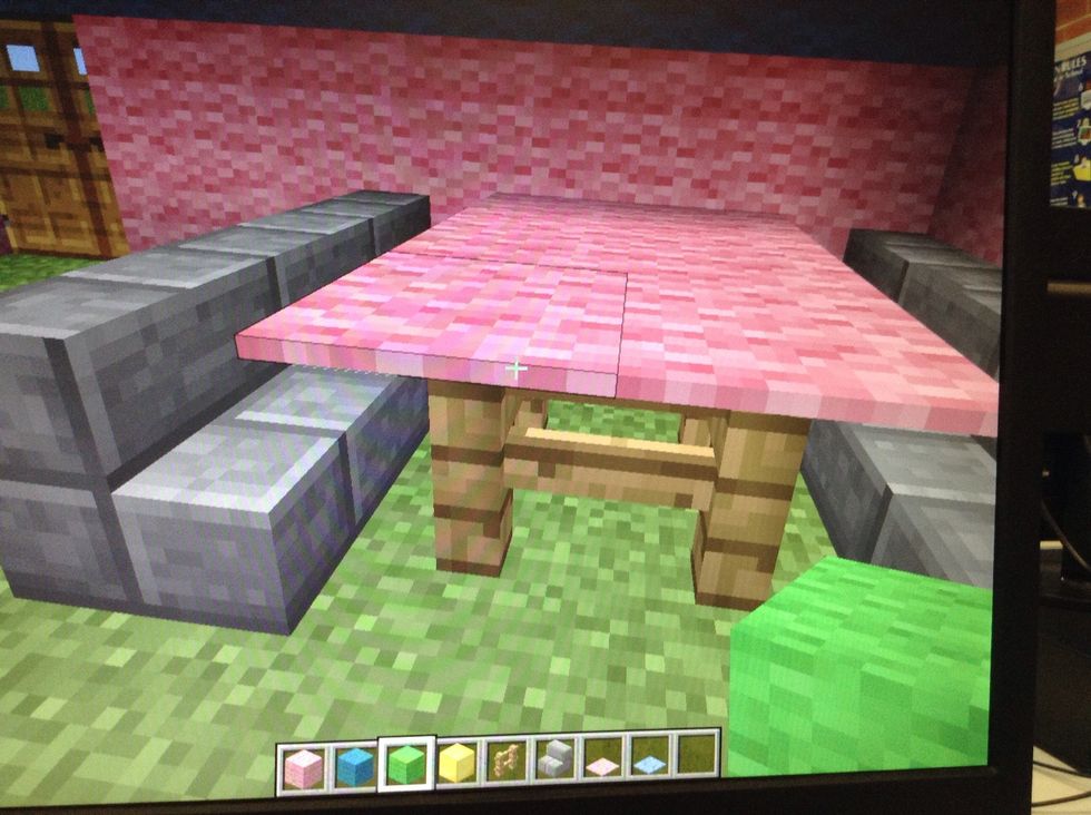 Add a table by using gates and carpet and make chairs by just putting two blocks on top of each other and add a block in front of the first one.