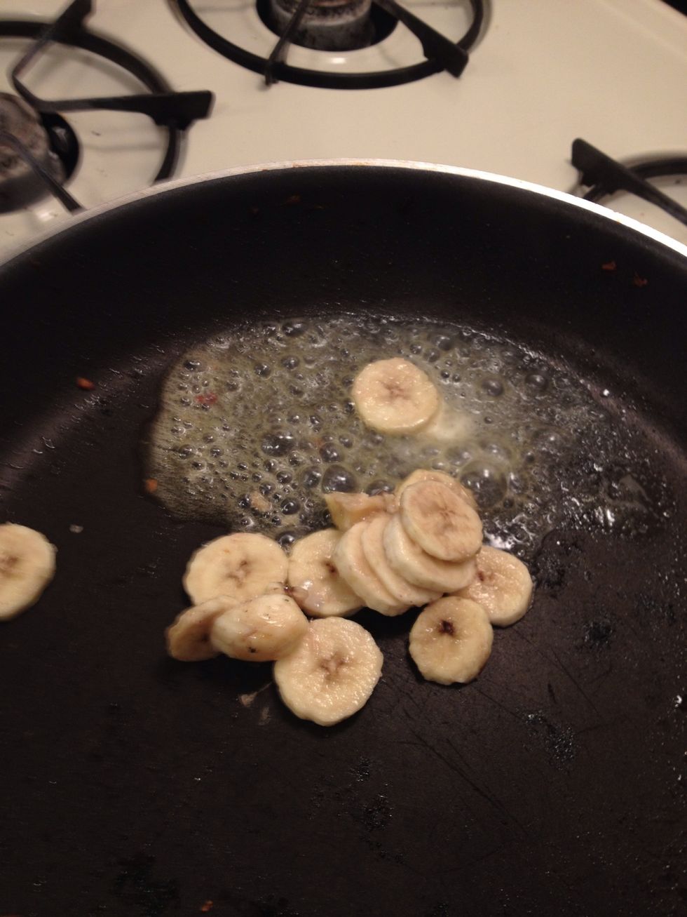 Add a Table spoon of EarthBalence spread and plop the bananas in the pan on low heat