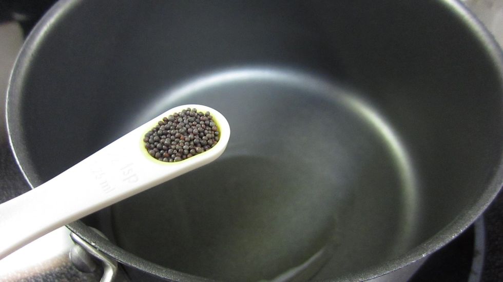Add a tablespoon of Olive oil and Black Mustard seeds into a pan and heat on medium until the mustard seeds start to pop. About 5 minutes. Black Mustard seeds protect against gastrointestinal cancer.