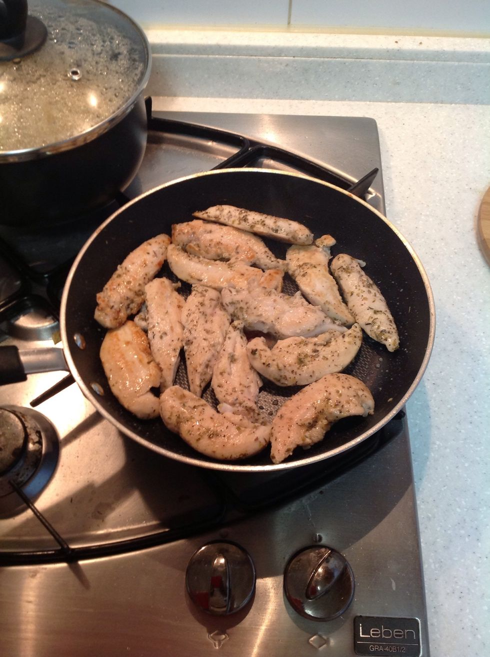 Add a tad bit of olive oil to a pan let it get hot and proceed to add your chicken breast(tenderloins) brown on both sides (about 1-2 mins each side)