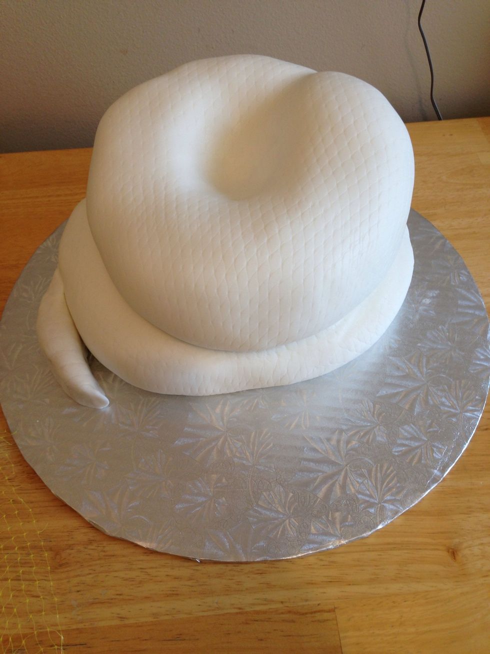 Add a tail made out of either fondant or rice cereal treats covered in the patterned fondant shaped to fit beside the bottom coil as if attached. I used the treats, as they are very easy to work with.