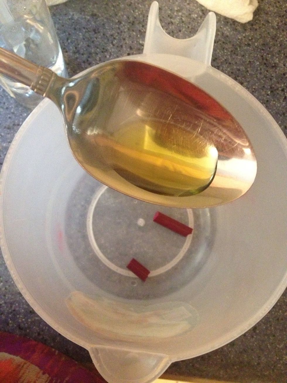 Add a teaspoon of olive oil and add to container with crayons