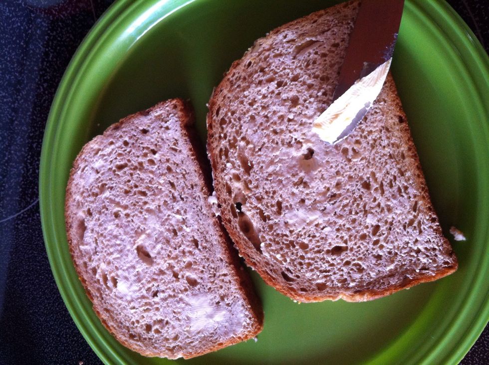 Add a thin layer of butter to one side of the bread.