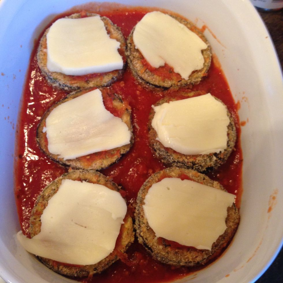Add a thin slice of cheese on top of each piece of eggplant.