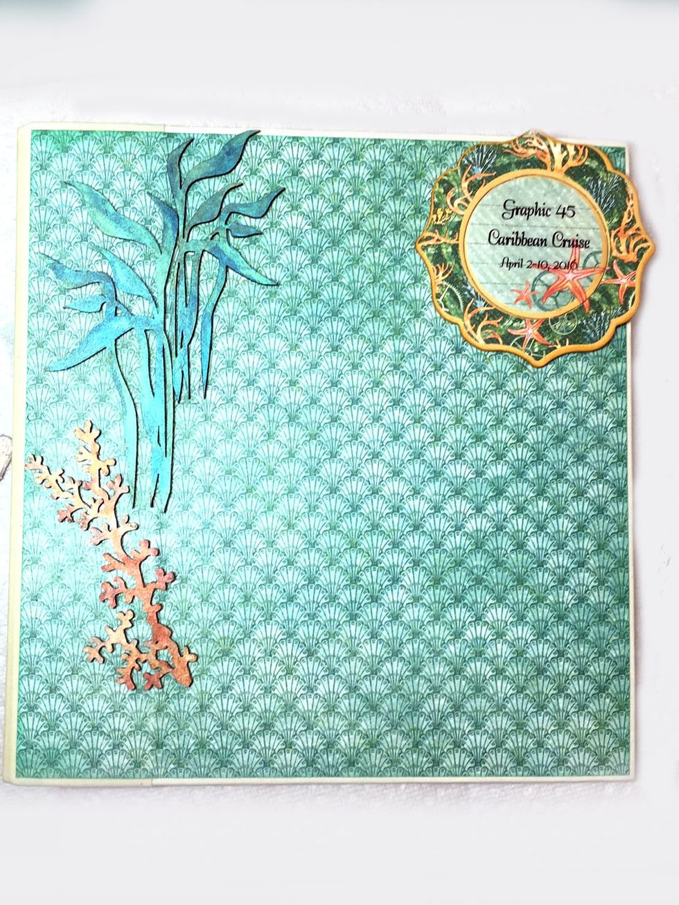 Add a title of your choice to the round chipboard piece and adhere in the upper right corner. (I printed my title on transparency paper and glued with clear drying glue) Add the seaweeds as shown.