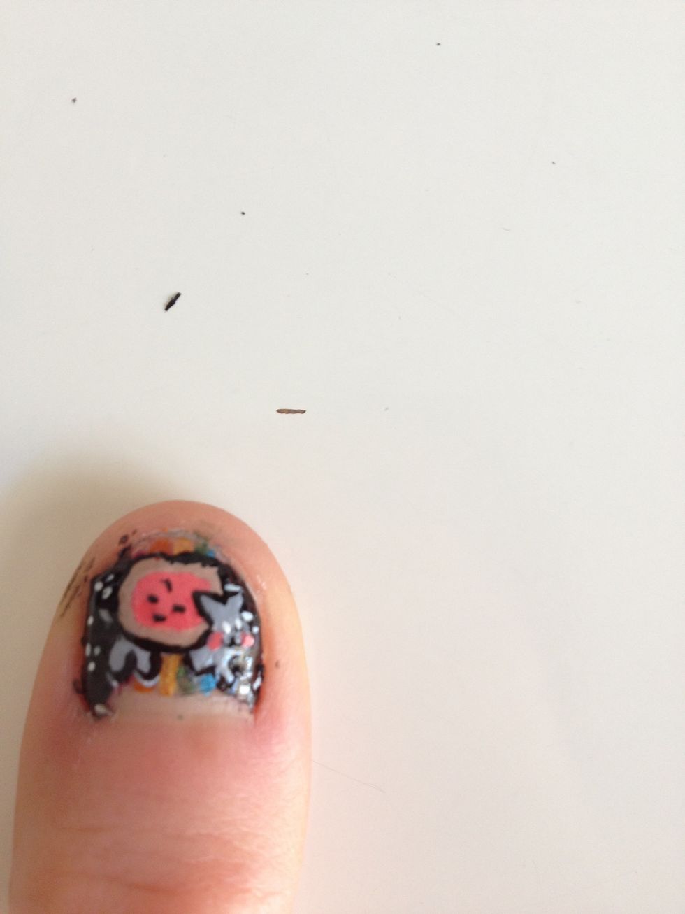 Add a top coat and then stick on your cat. Peel it off of the baggie with tweezers.  Stick the cat onto your nails and then wait a bit before adding the last top coat.