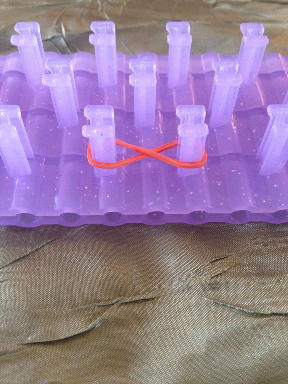 Add a twisted band from one loom to another right next to it.