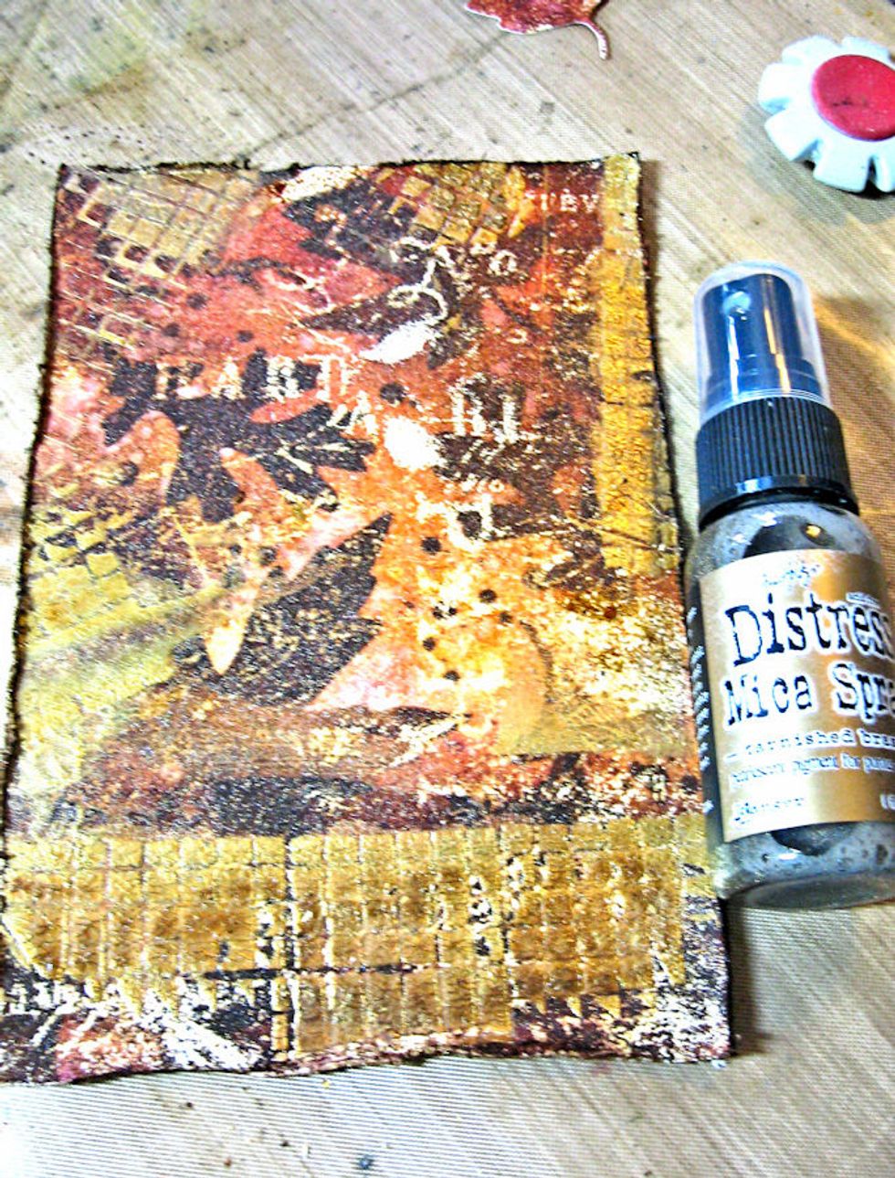 Add a very light misting of Tarnished Brass Mica Spray. Be careful not to over spray the image or you will cover up the inking/stamping.  We just want a light shimmer.