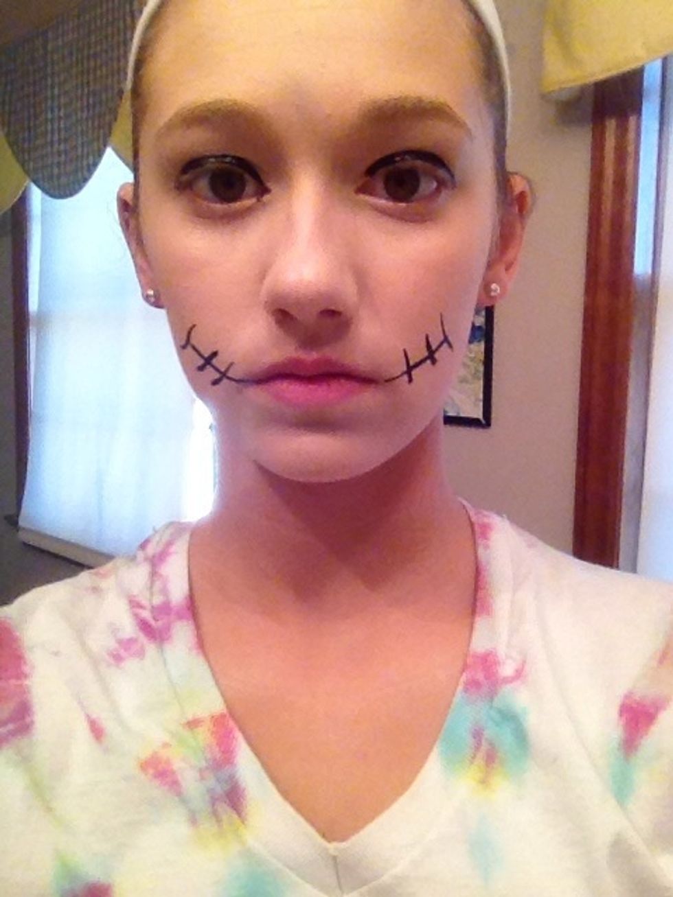 Add a VERY thick layer of eyeliner on your eye.