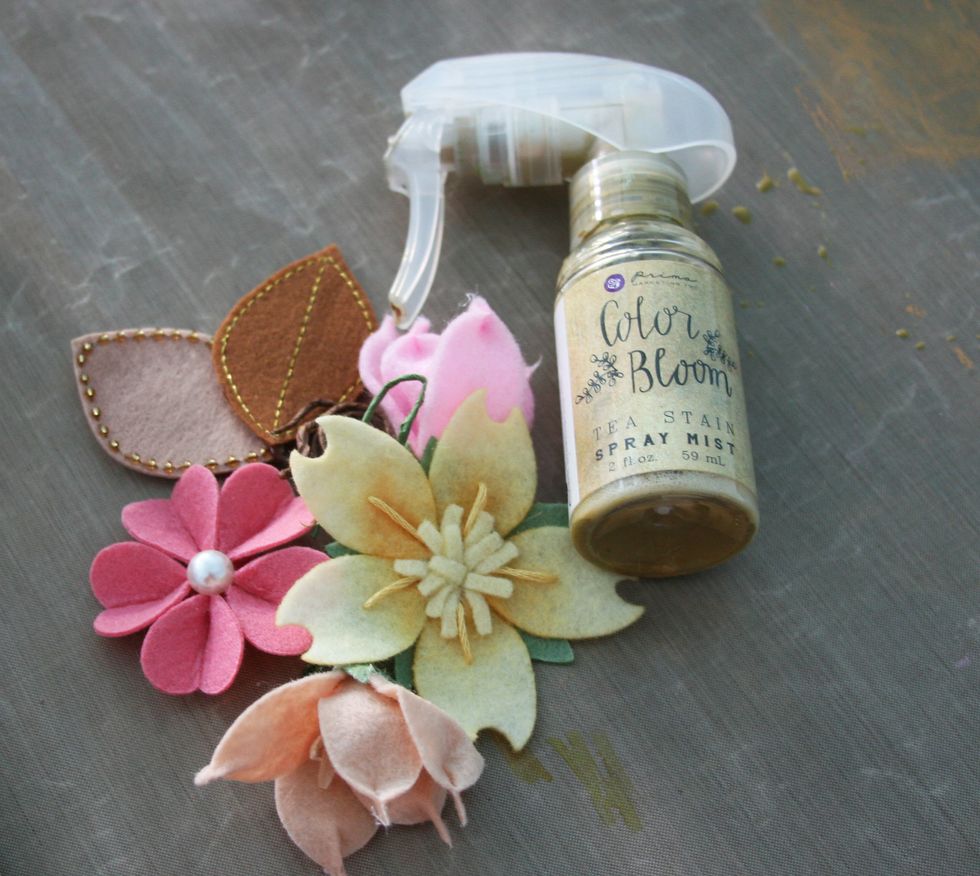 Add a vintage effect to all embellishments by spraying with Color Bloom Spray - Tea Stain. Dry.