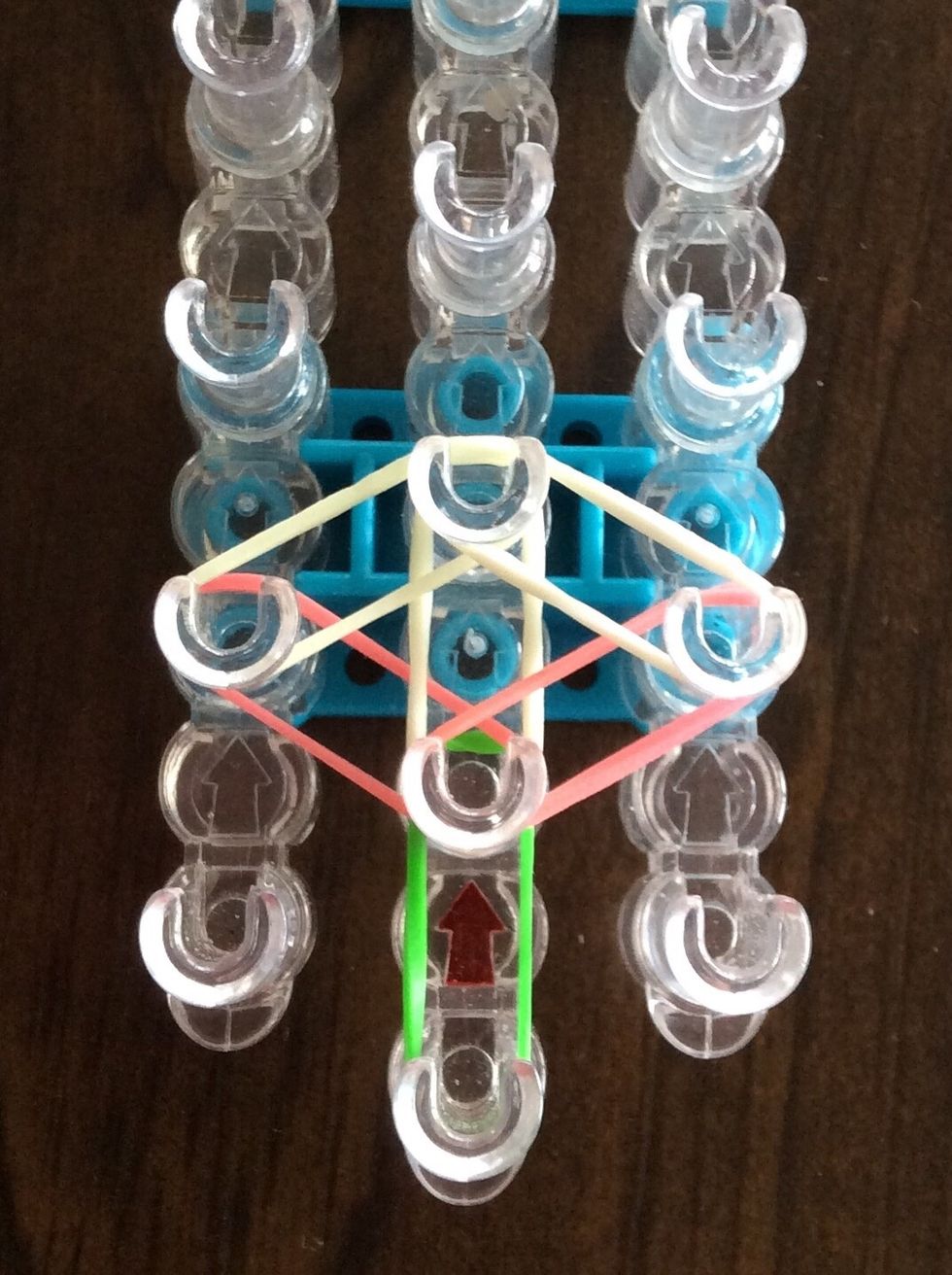 Add a white band from the second right peg to the third middle peg.