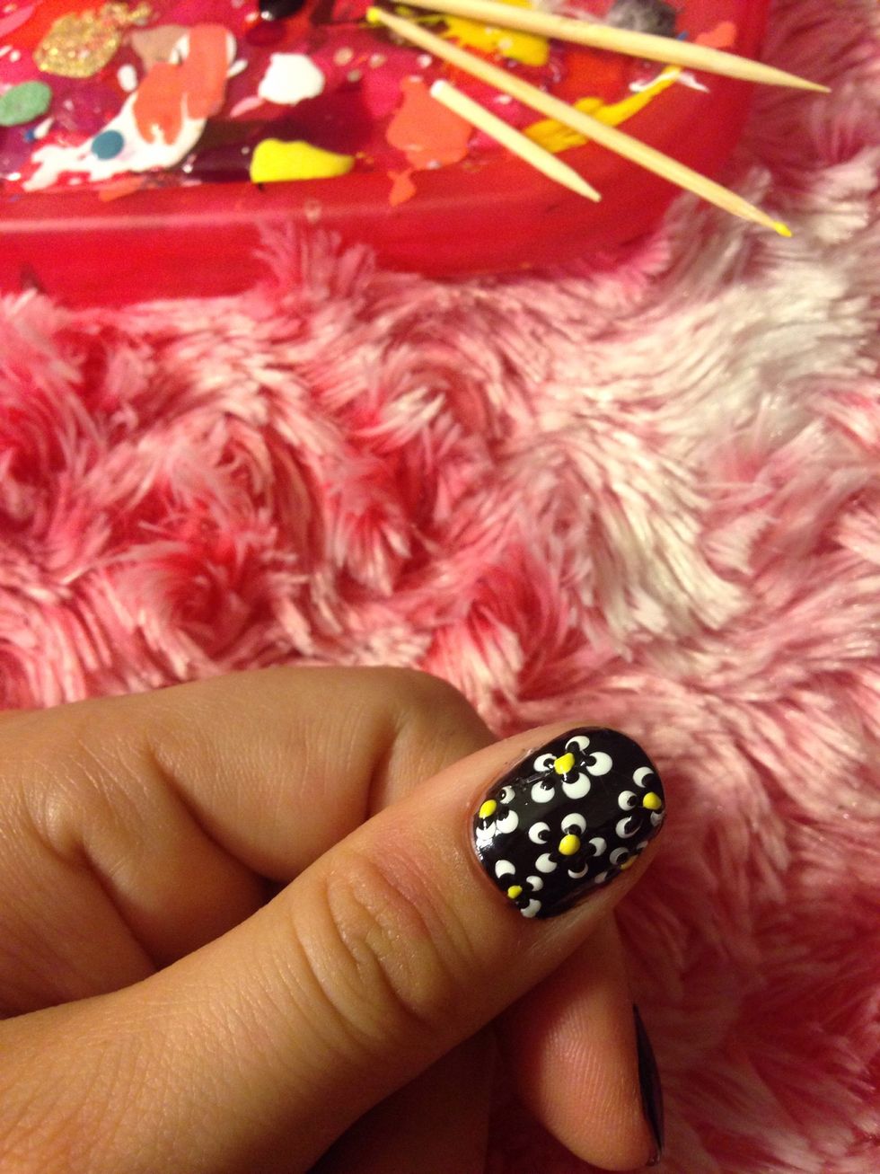 Add a yellow dot in the middle of each flower