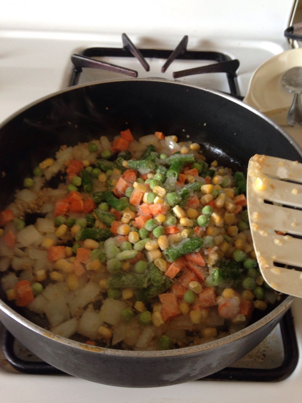 Add about 1 1/2 cups of frozen mixed veggies