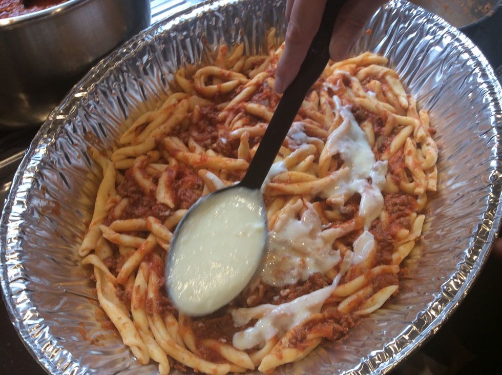 Add about 1 third of a ladle of b\u00e9chamel sauce to the pasta. Spread evenly.