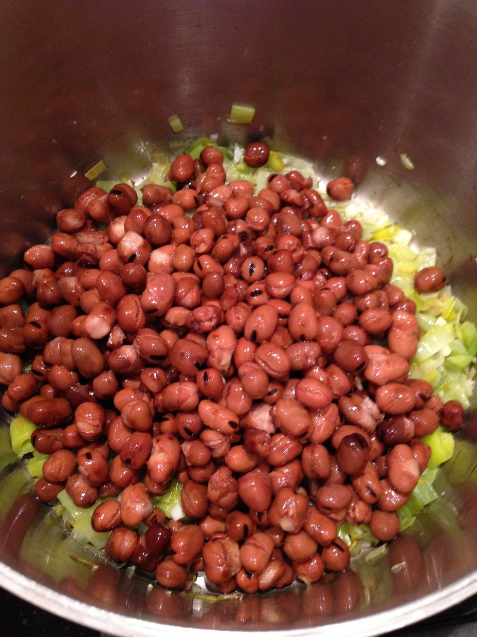 Add about 2 pounds of Fava beans. I'm using canned Favas. Note: If you use frozen Favas you'll want to cook them until they float in the water that you're adding in an upcoming step!