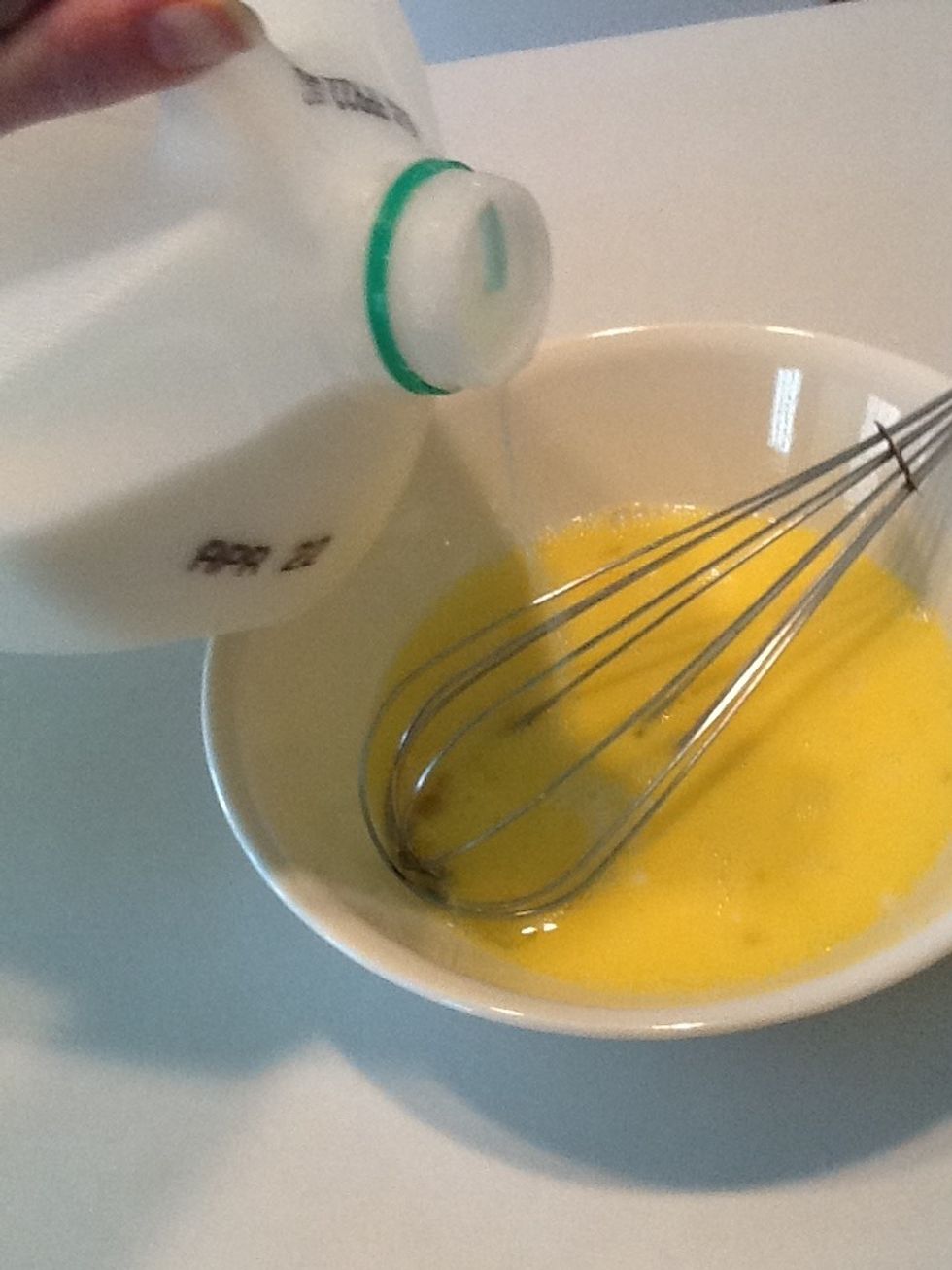 Add about 3 splashes of milk then whisk. Yes, I know that isn't a precise measurement. But cooking should be fun, so don't get too stressed over this step. Make it a splash, not a puddle!