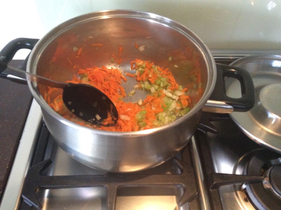 Add about 4 table spoons of oil into the saucepan and heat until little bubbles are visible. Then add the carrot, onion, and celery.