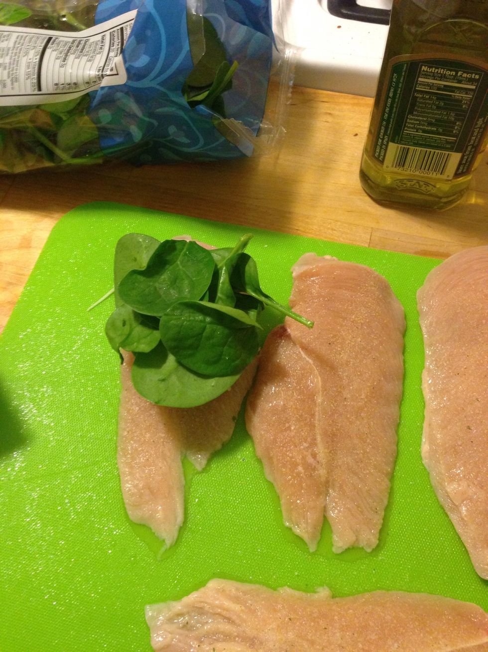 Add about 5-8 spinach leaves per chicken breast. I heated the spinach in the microwave for 15 seconds to make t easier to fold later.