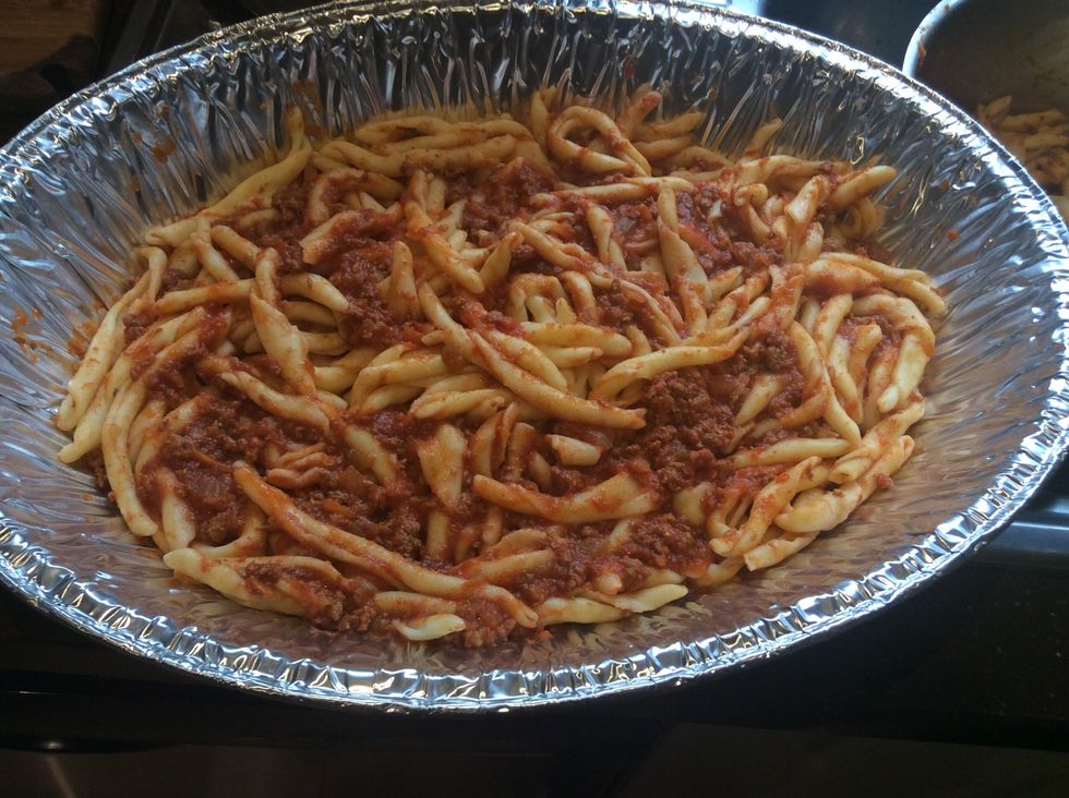 Add about one third of the pasta to the tray. Spread evenly.