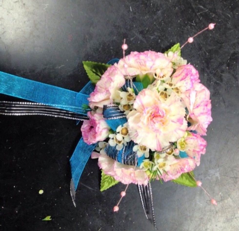 Add accents with corsage glue into the bow to add more color or to make it look more fancy, only if you would like. Then you have your wrist corsage completed & it's ready to wear.