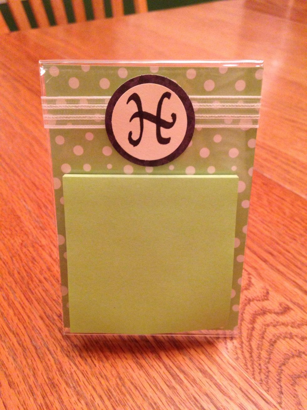 Add additional gifts if you like.  I made this from a clear, acrylic frame; added scrapbook paper, ribbon, and initial then hot glued a pack of post-it notes on top.