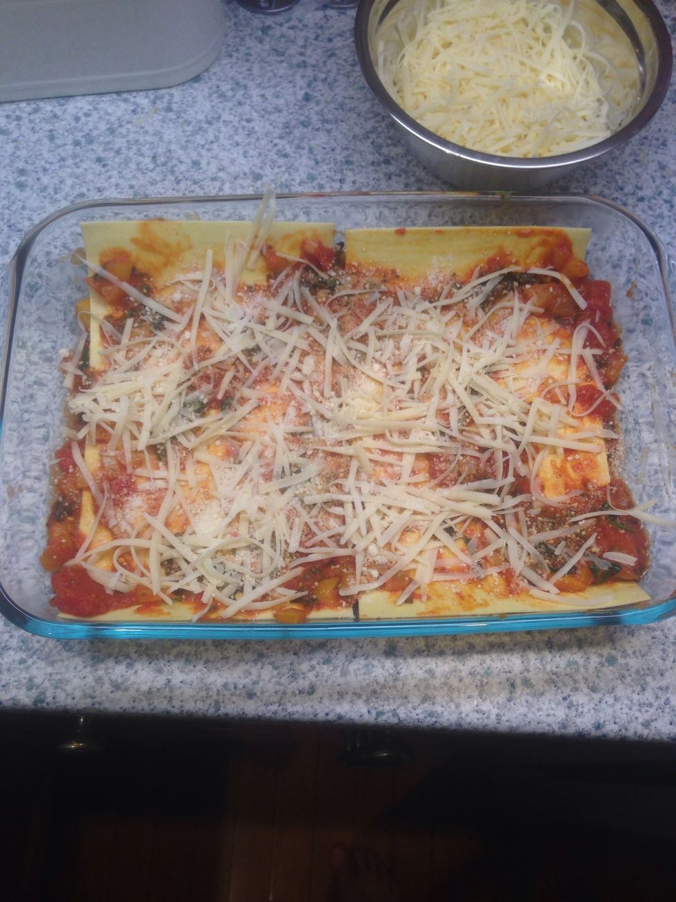 Add additional sauce to top. Sprinkle cheese. Repeat until all lasagna sheets are used.