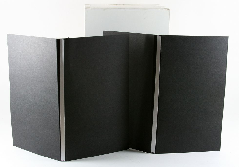Add adhesive tape to the back of each insert. This is not to permanently affix them in the book...just to keep them in place while you punch the holes.