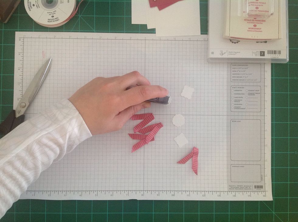 Add adhesive to the backs of the stamped and punched images.