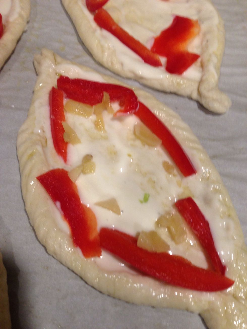 Add Alfredo sauce and start layering toppings