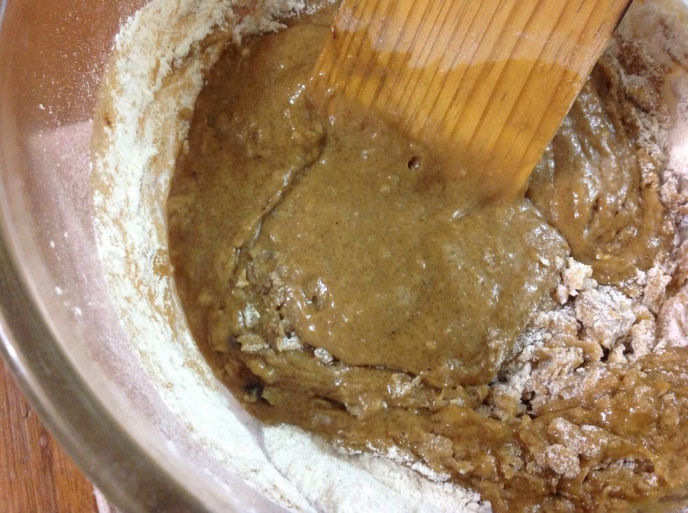 Add all humid ingredients at once over the dry ones. Stir until combined, do not over mix as gluten (protein from wheat, it comes in the flour),will develop and you will end up with stones once baked.