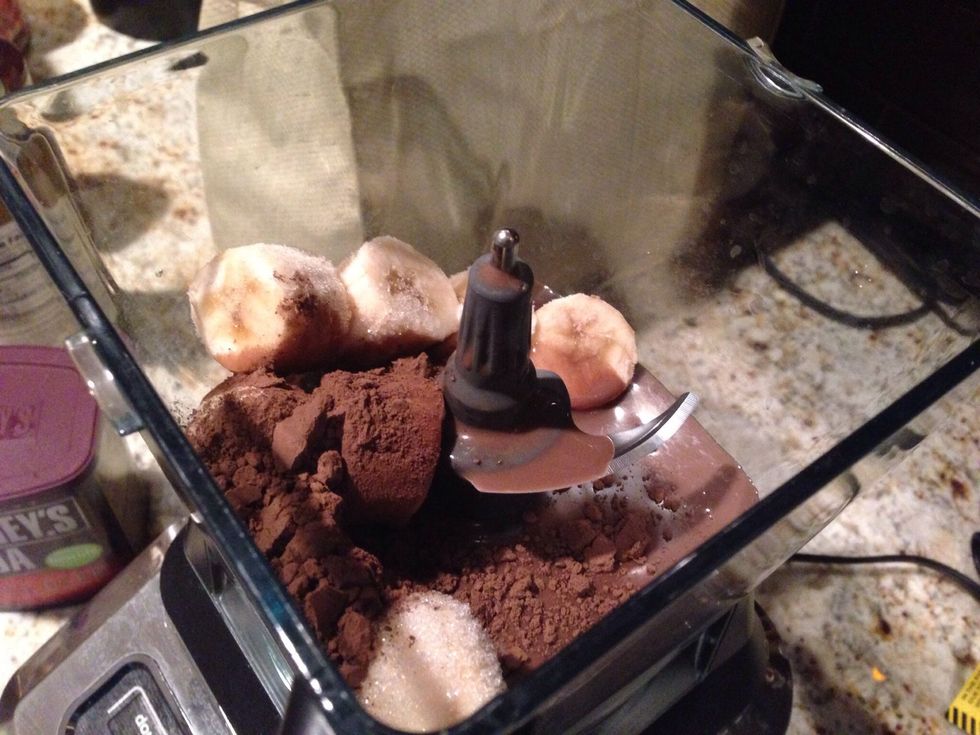 Add all ingredients into a food processor, including 1 cup almond milk, 1 cup frozen banana chunks, 1 tsp. vanilla, and 1 tbls. unsweetened cocoa.