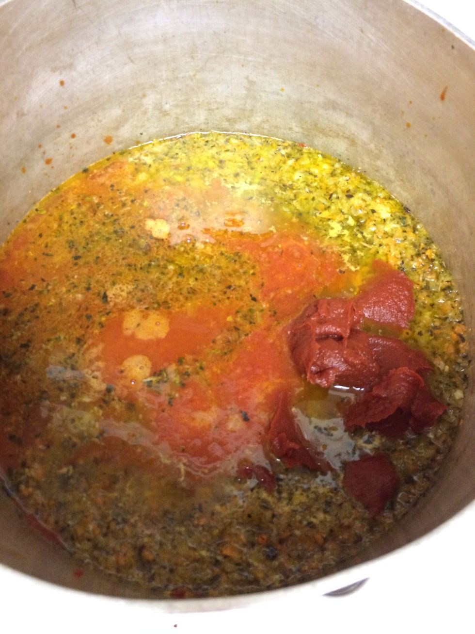 Add all of that in and fill the empty crushed tomato can with water and pour that in right away