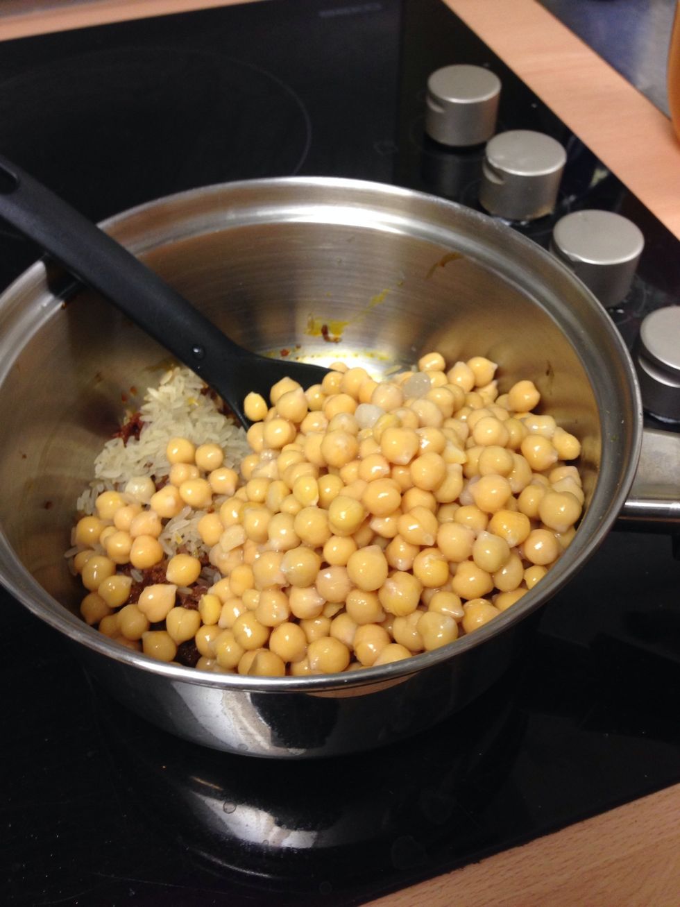 Add all of the chickpeas to the pan around about the same time as the rice. Mix well.