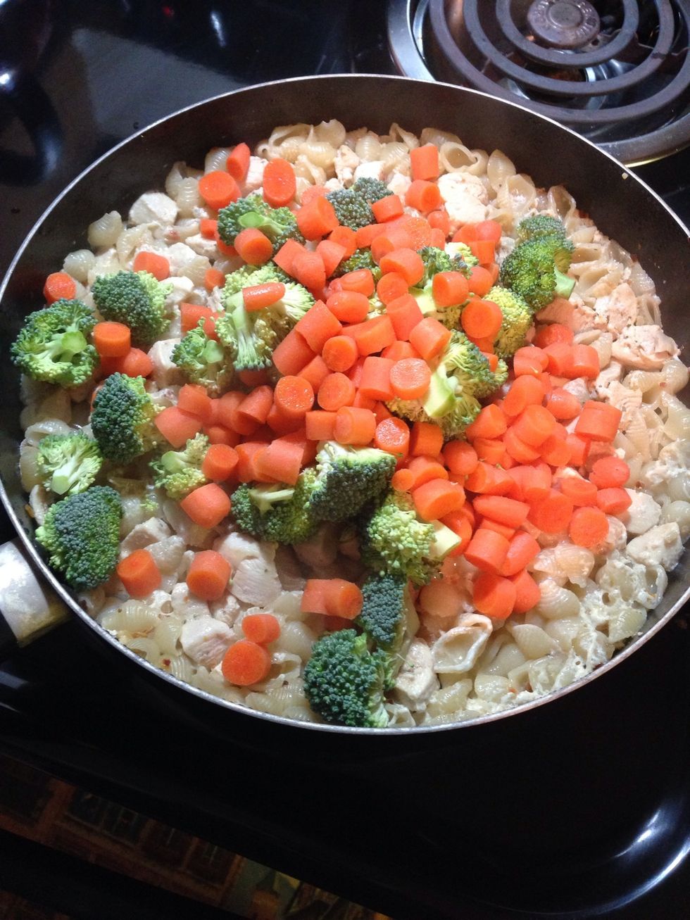 Add all of the vegetables into the pan and mix everything together. Return the lid.