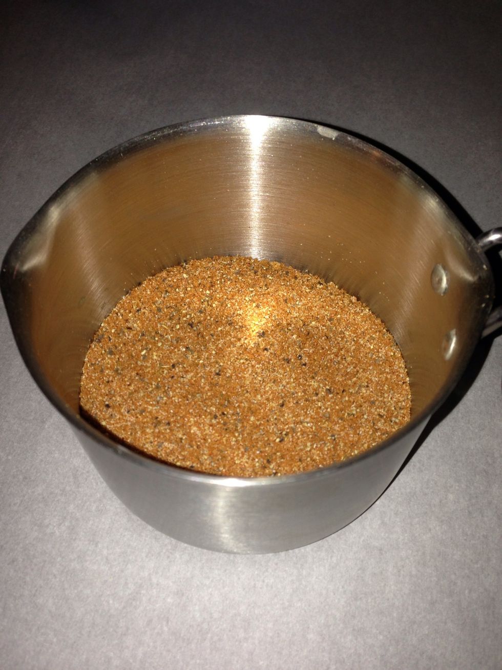 Add all seasonings to a cup and mix to make the rub.  Note that there is no added salt to this recipe due to the amount in the bacon and sausage already.  (This picture shows double the amount)