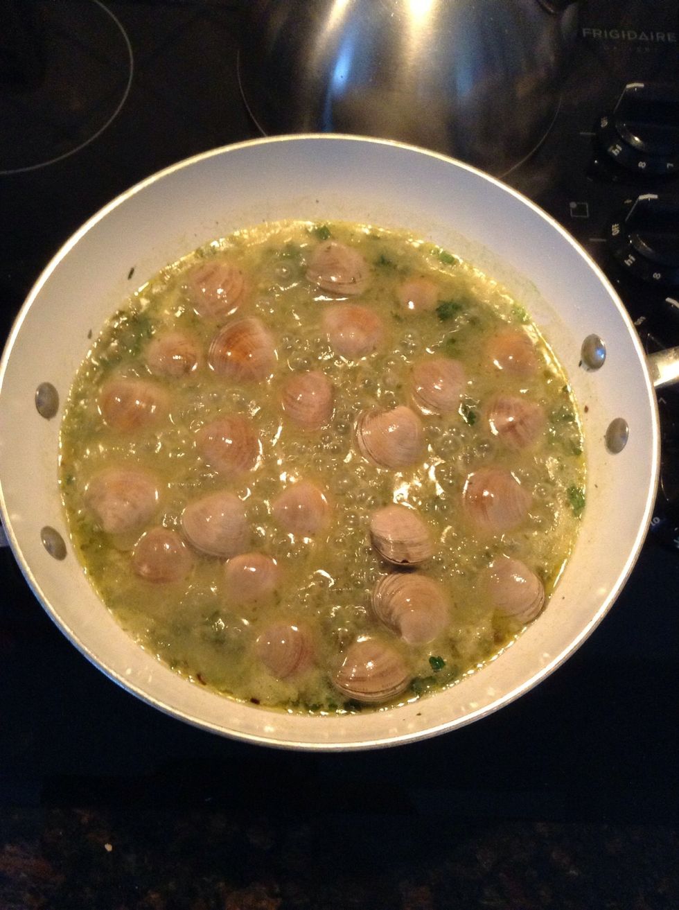 Add all the good clams to the simmering white clam sauce.