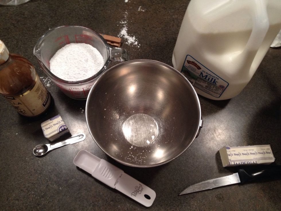 Add all the ingredients-3 cups of powdered sugar, 2 tablespoons of milk, 5 2/3 cups of butter or margarine, and 1 1/2 of vanilla extract.