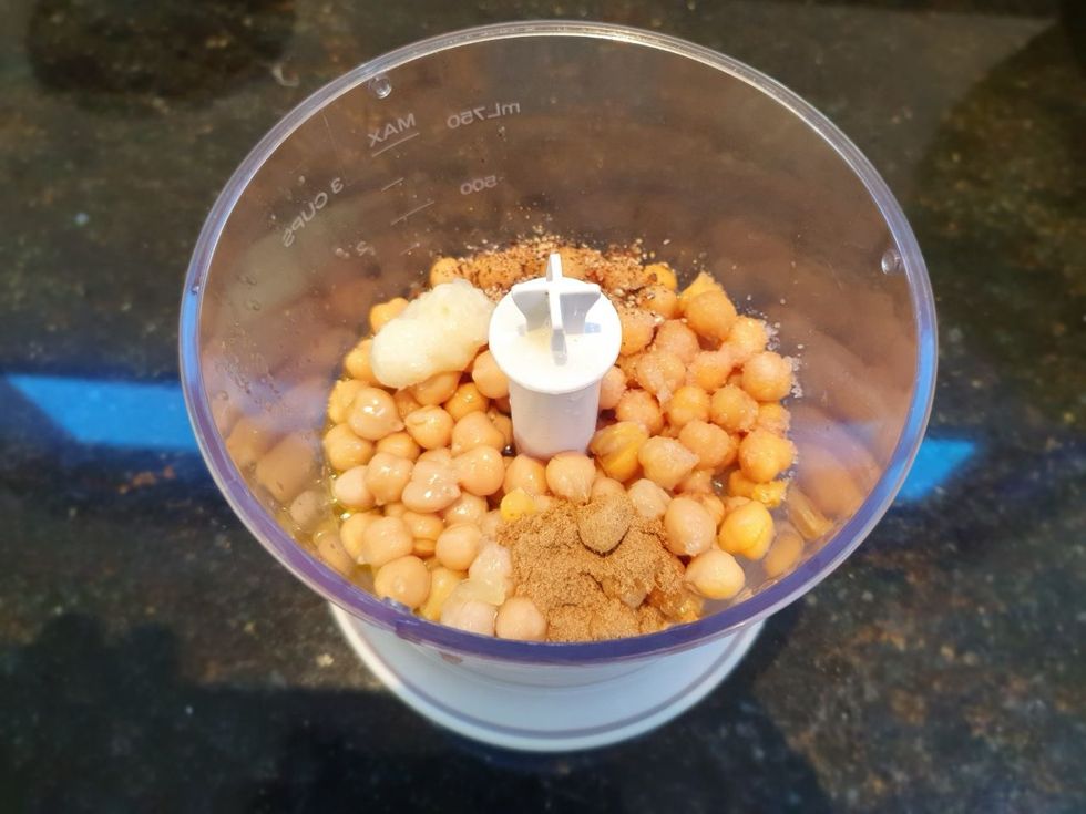 Add all the ingredients without the Tahini to a food processor (use only 1/2 cup of the water).